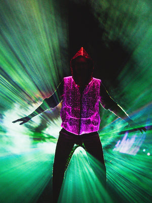 animated man wearing the NEBULITE vest on a festival, with lasers in the background